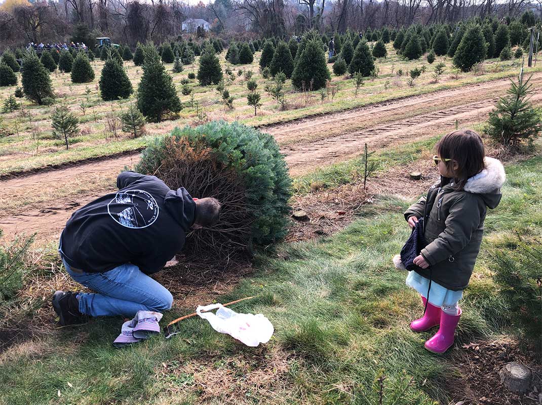 A joyful family tradition – Pudding (right) and her family visiting their local Christmas Tree farm to find, fell and bring home the perfect tree to decorate for the holidays.