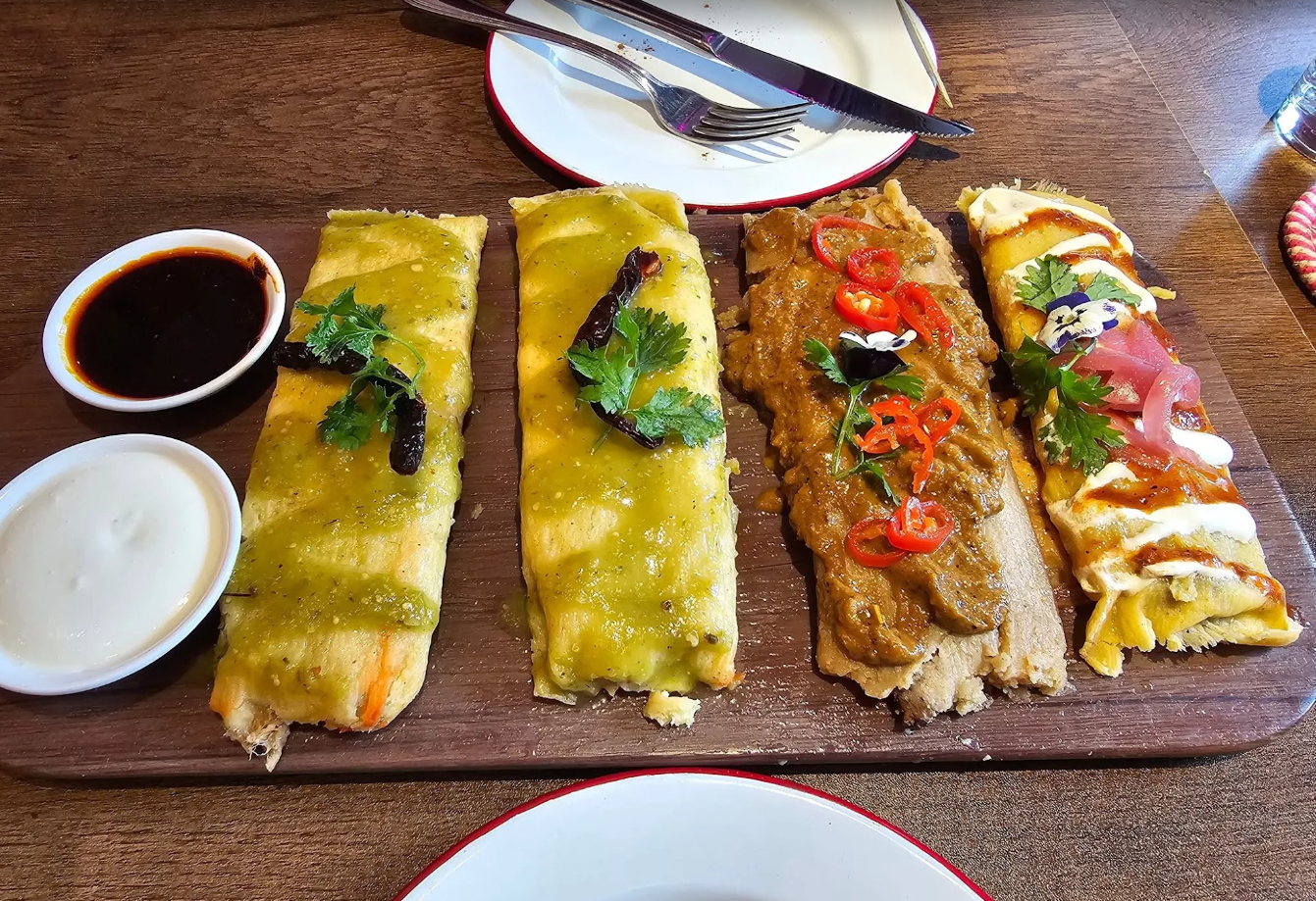 Tamales comprise steamed corn dough filled with savoury or sweet ingredients, wrapped in corn husks that keep them moist.