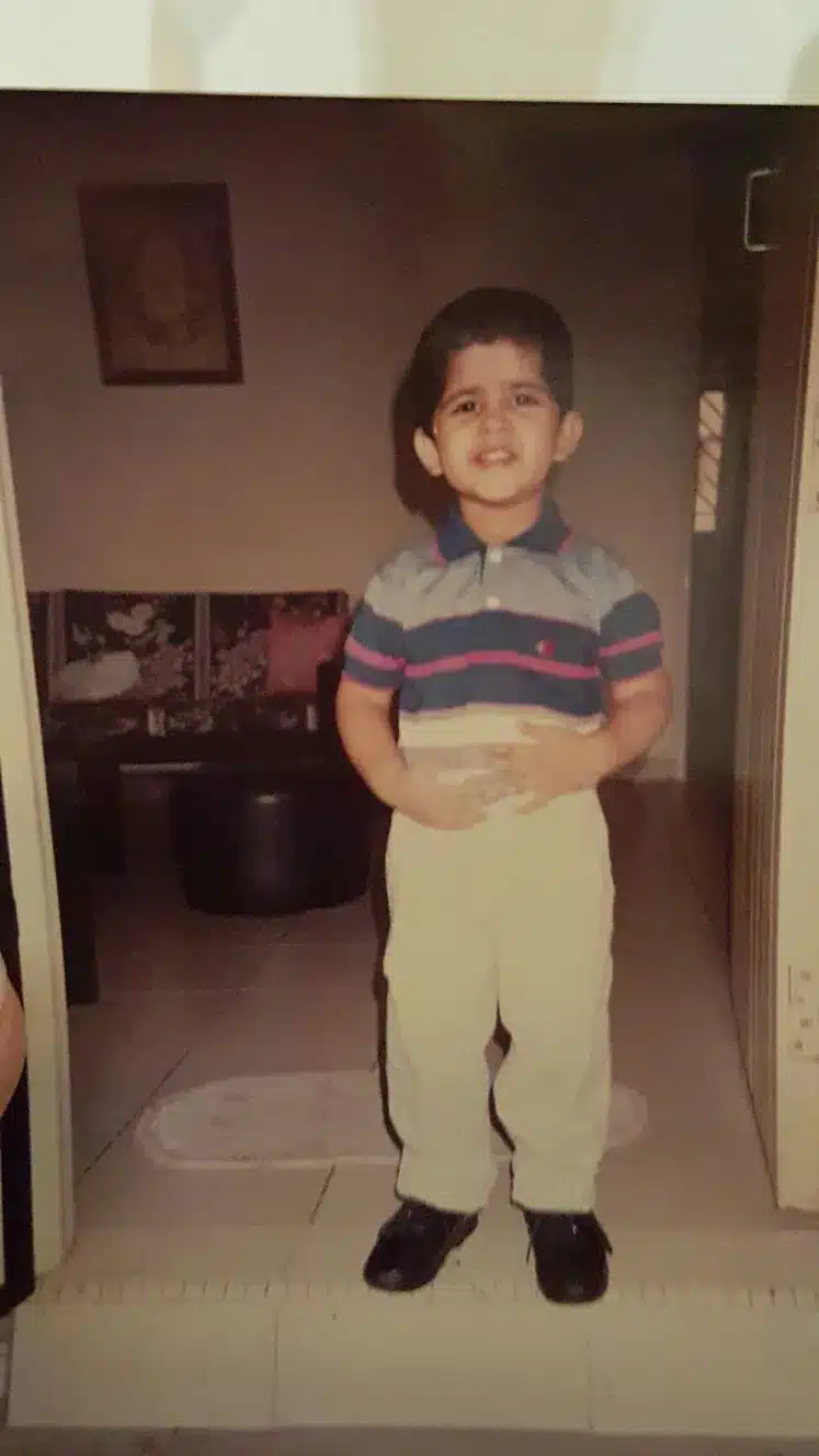 Kartik as a child; at his family home in India.