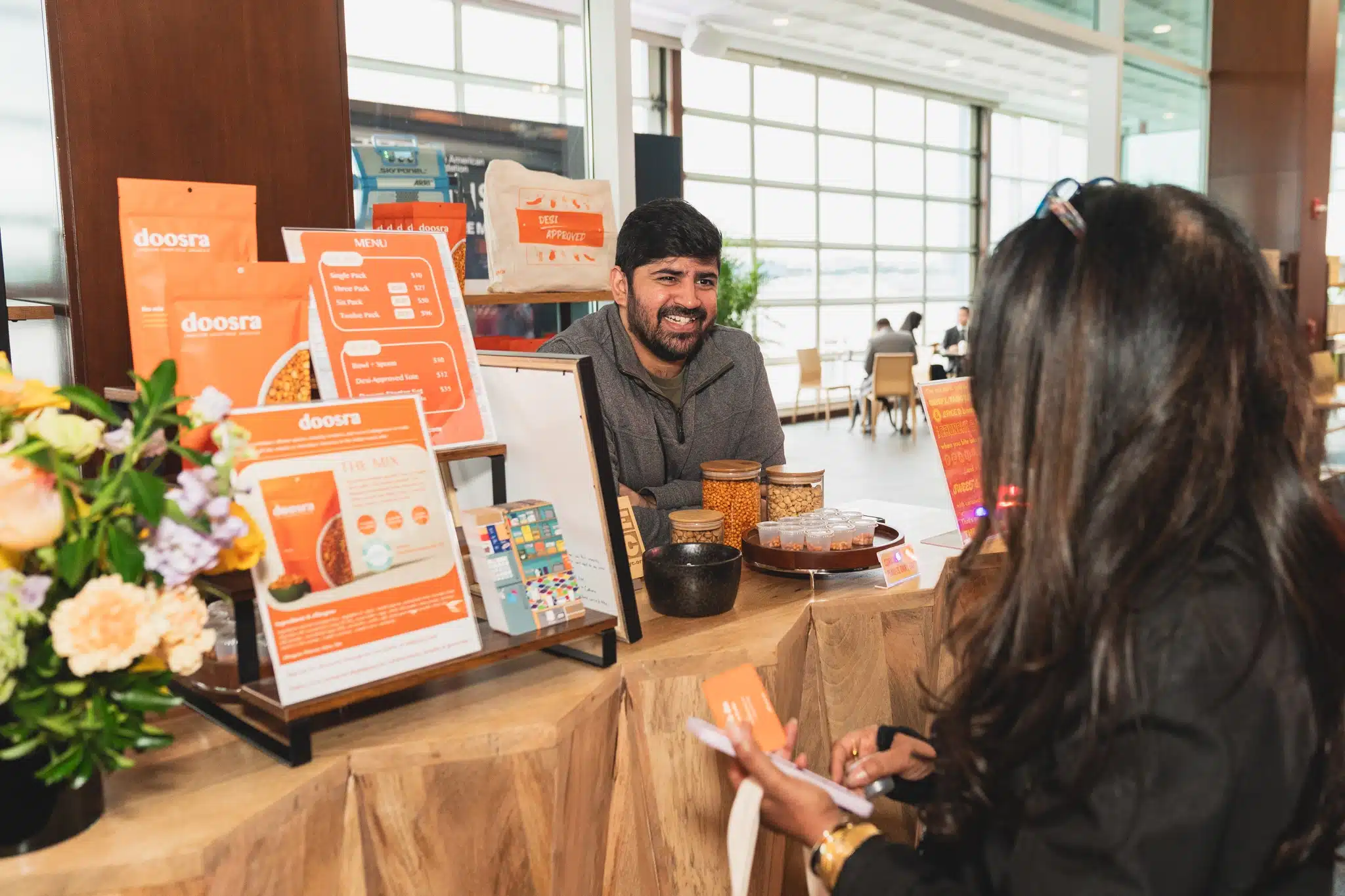 Kartik speaking with a potential customer at a farmer’s market.